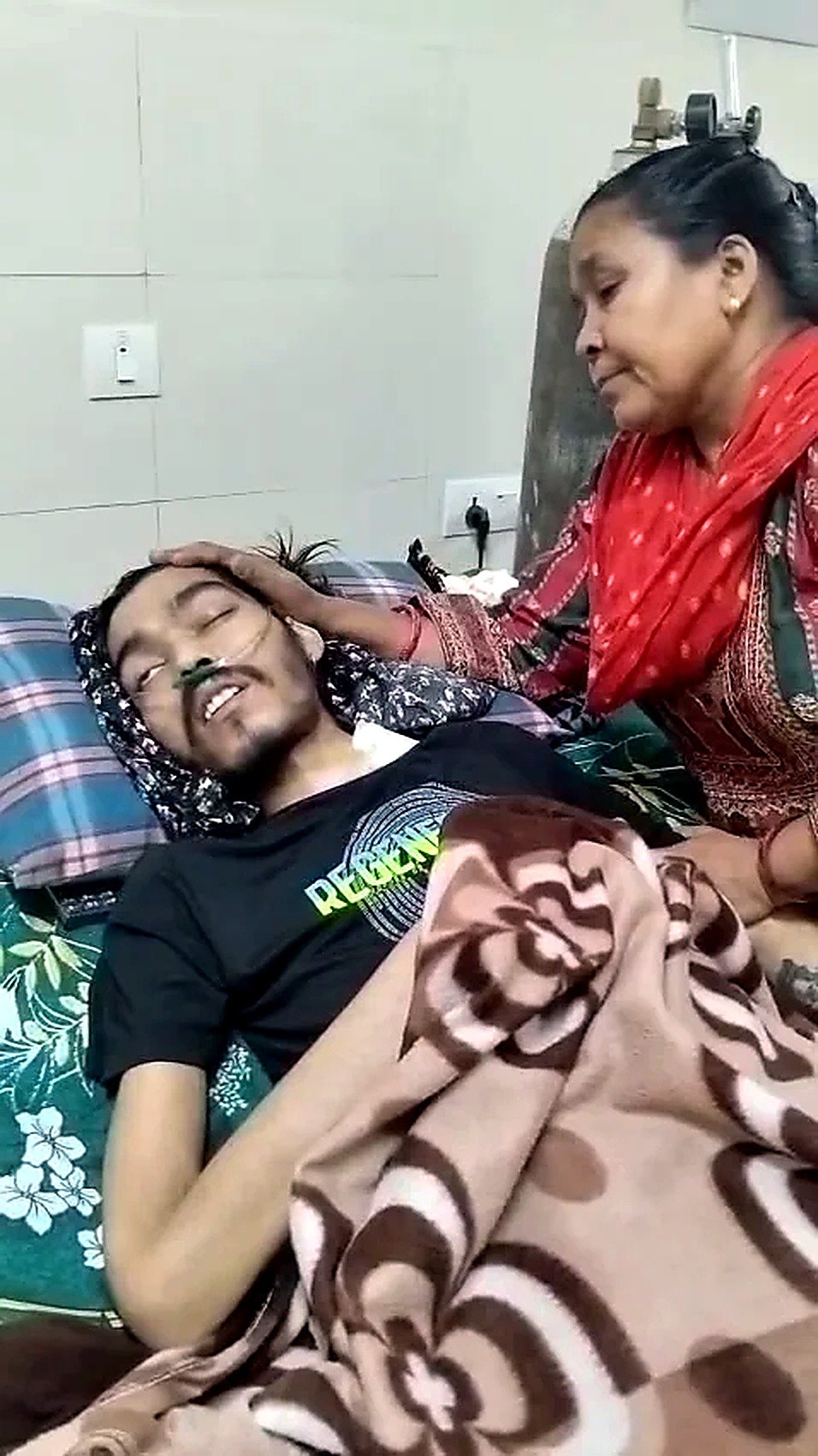 Puran’s mother sitting beside him and offering comfort